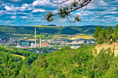 Panoramic view of trees and buildings against sky