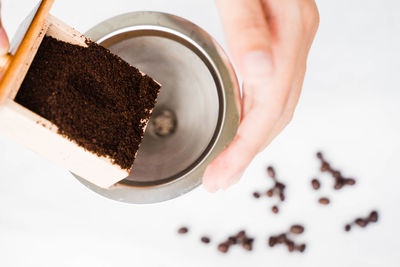 Close-up of hand holding coffee cup