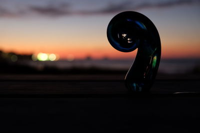 Close-up of silhouette water against sky during sunset