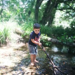 Full length of boy playing in water