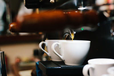 Close-up of coffee cup on coffee machine 