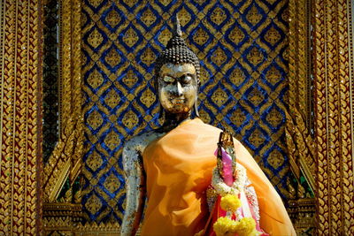 Statue of buddha against building