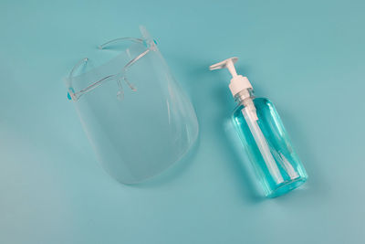 High angle view of bottle on blue glass