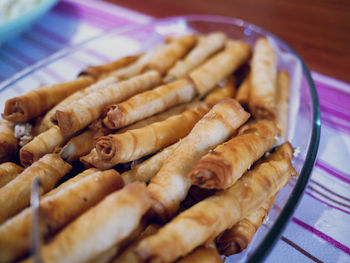 Close-up of spring rolls in bowl on table