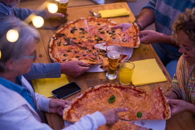 High angle view of people eating pizza at restaurant