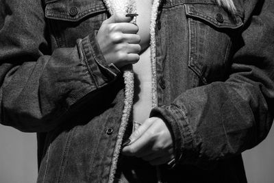 Midsection of woman wearing denim jacket