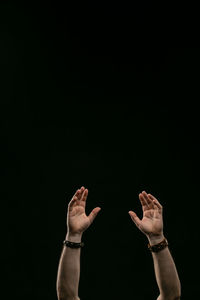 Midsection of person standing against black background