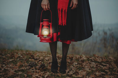 Low section of woman with red lantern