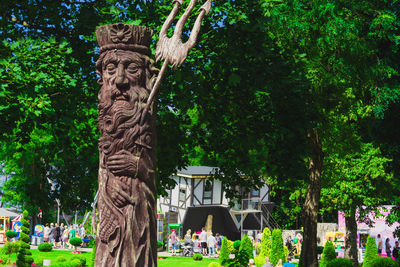 Statue against trees