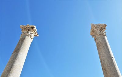 Low angle view of statue against blue sky