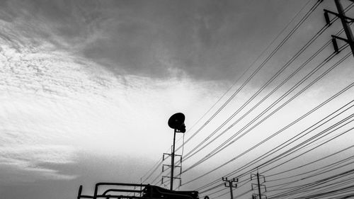 Low angle view of telephone pole against sky