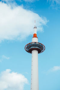 Low angle view of communications tower and building against sky