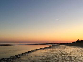 Scenic view of sea against clear sky during sunset