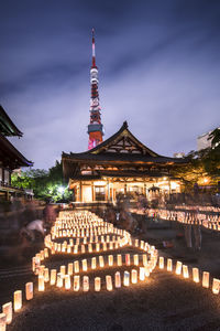 Handmade japanese washi paper lanterns aligned in circles illuminating the zojoji temple.