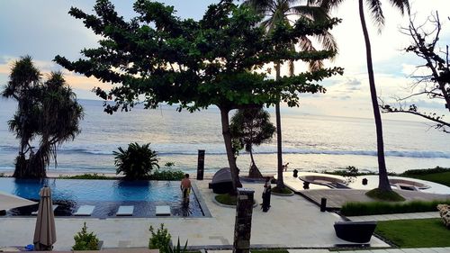 View of swimming pool at beach during sunset