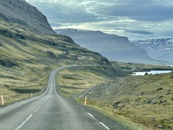 Road amidst mountains against sky