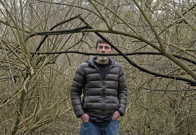 Full length portrait of a man standing in snow