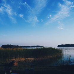 Scenic shot of calm lake against blue sky