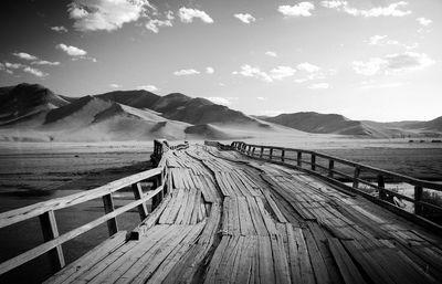 View of pier leading towards sea