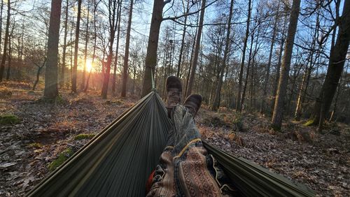 Rear view of woman walking in forest