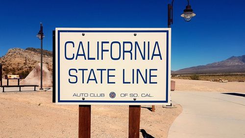 Information sign on road against clear sky