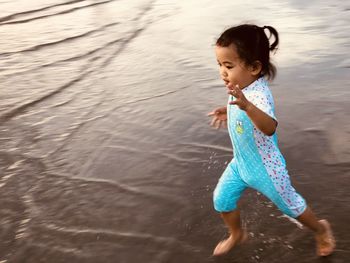 Cute girl running at beach
