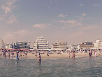 People on beach against sky