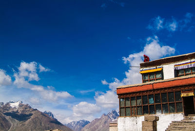 Low angle view of building against cloudy sky