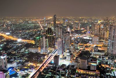 Aerial view of illuminated city buildings at dusk