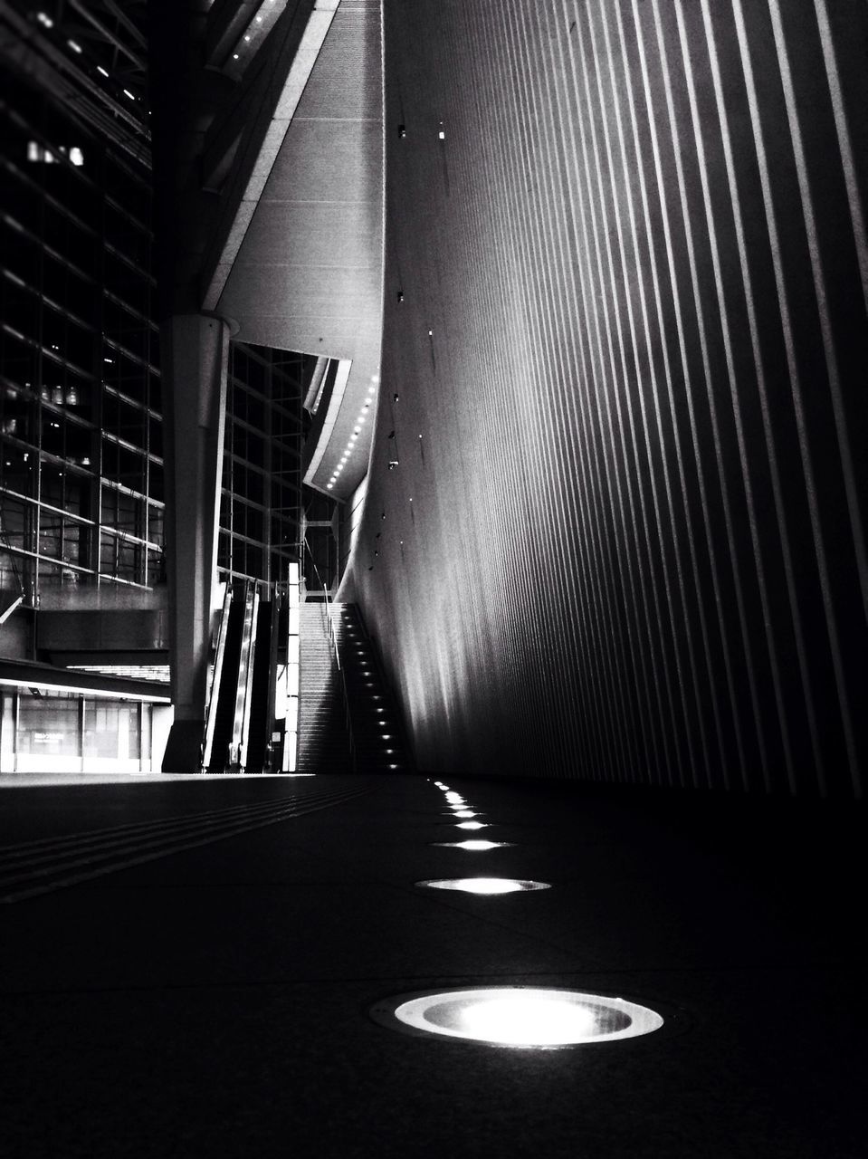 indoors, the way forward, diminishing perspective, empty, illuminated, built structure, transportation, architecture, narrow, one person, vanishing point, corridor, tunnel, wall - building feature, absence, shadow, railing, dark, subway, sunlight