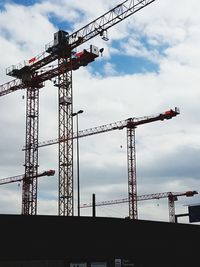 Low angle view of crane against sky