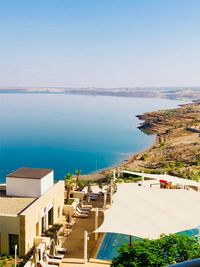 High angle view of townscape by sea against sky