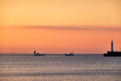 Scenic view of sea against orange sky