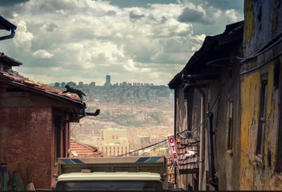 Buildings in city against cloudy sky