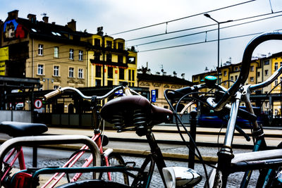 Bicycles on street against buildings in city