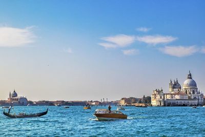 Boats in sea against sky