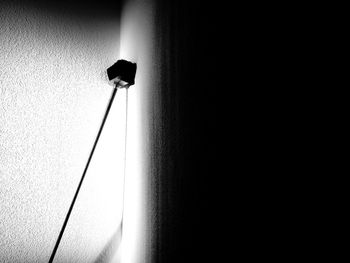 Low angle view of electric lamp on wall