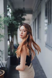 Portrait of beautiful young woman standing outdoors