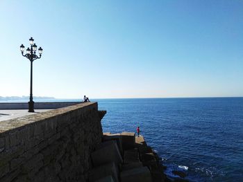 Scenic view of sea against clear blue sky