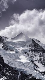 Scenic view of mountains against cloudy sky