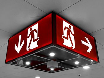 Low angle view of illuminated sign on wall