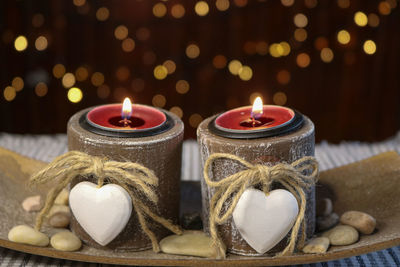 Close-up of illuminated candles on table