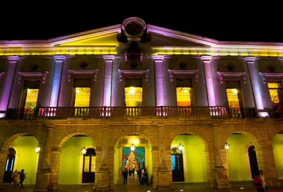 Low angle view of illuminated building at night