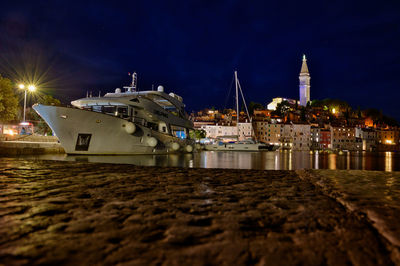 Boats in sea against sky at night