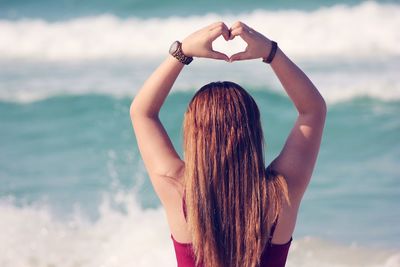 Rear view of a woman against the sea