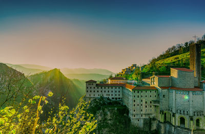 Panoramic view of buildings and mountains against sky