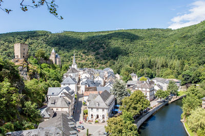 Houses in town against clear sky