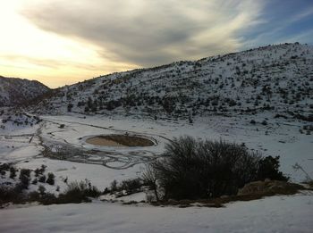 Scenic view of snow covered mountains against sky