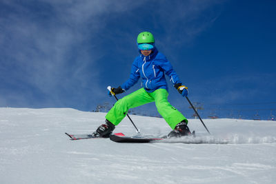 Man skiing on snow covered field