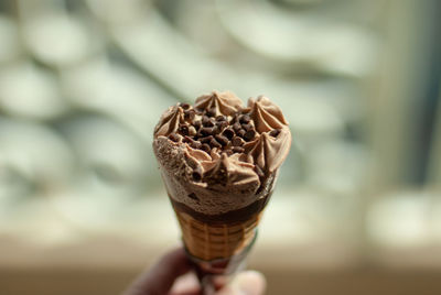 Close-up of hand holding ice cream